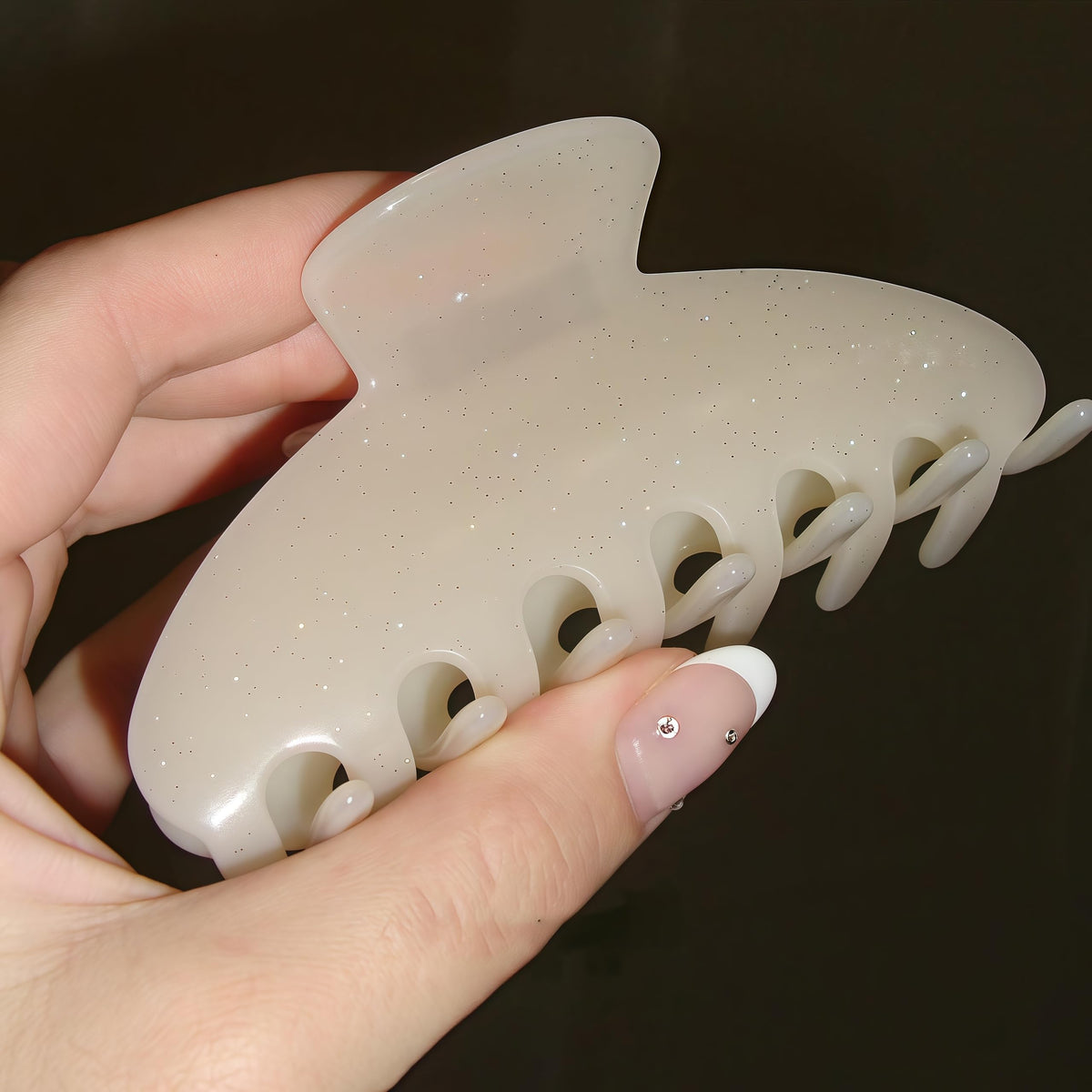 OideGuiing hand holding clip for scale showing 4-inch practical size