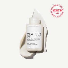 Olaplex Nº.5 pump dispensing conditioner to demonstrate concentrated creamy texture and control