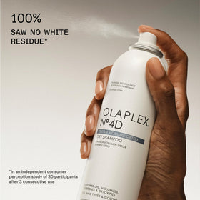Applying Olaplex Nº.4D directly to scalp to show targeted oil control and lift