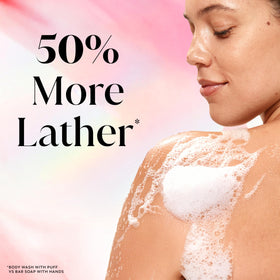 Person lathering Olay body wash in shower for refreshed skin