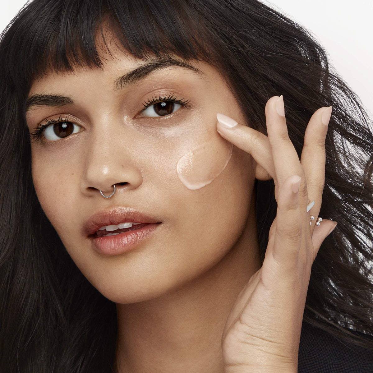 Olay product with ingredient callouts showing peptides and niacinamide benefits