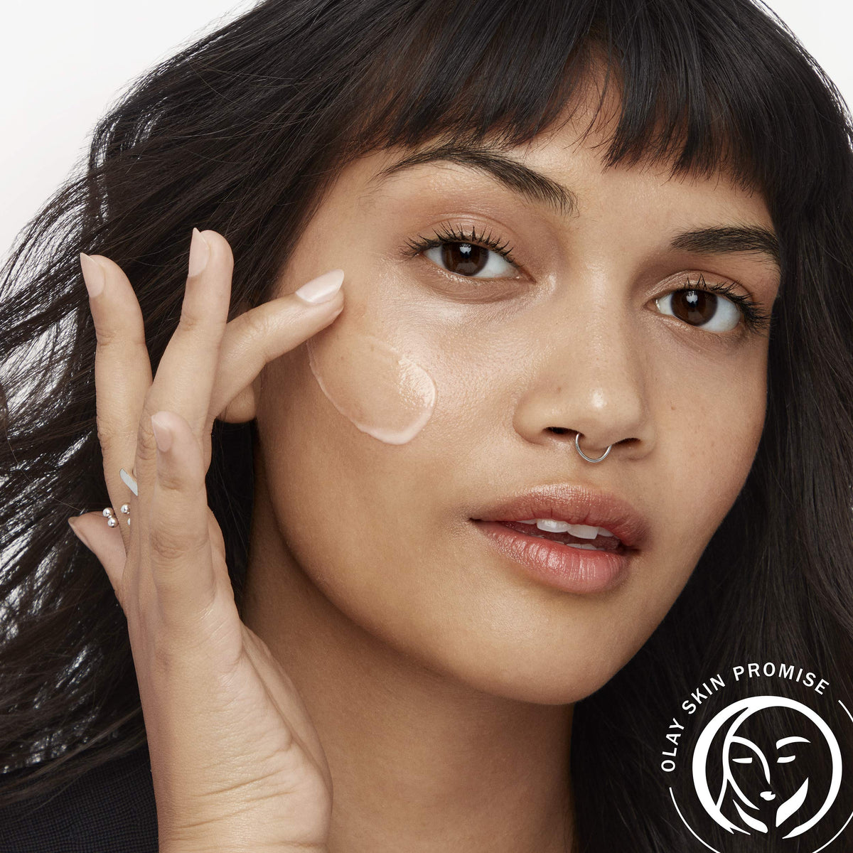 Olay serum being smoothed on hand for quick-absorbing hydration