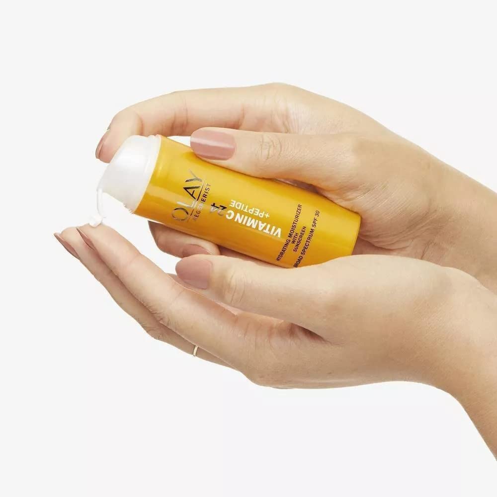Olay moisturizer on bathroom counter in morning light conveying brightening routine