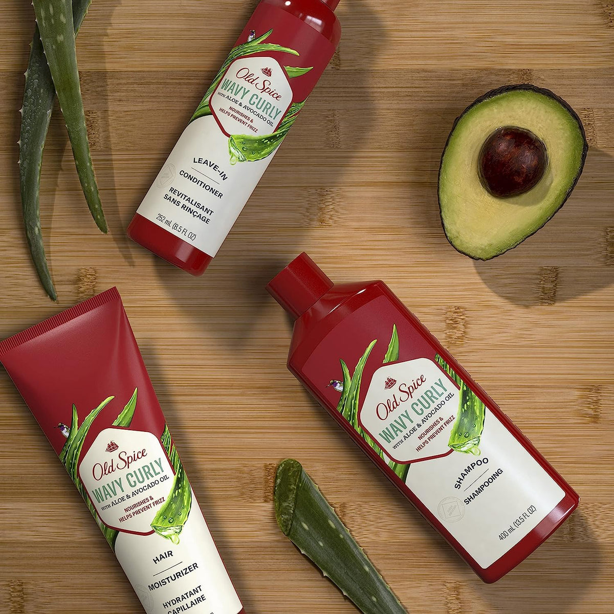 Old Spice leave-in in hand being applied to damp hair for frizz control and curl definition