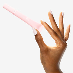Olive & June being applied around a cuticle showing targeted moisturization