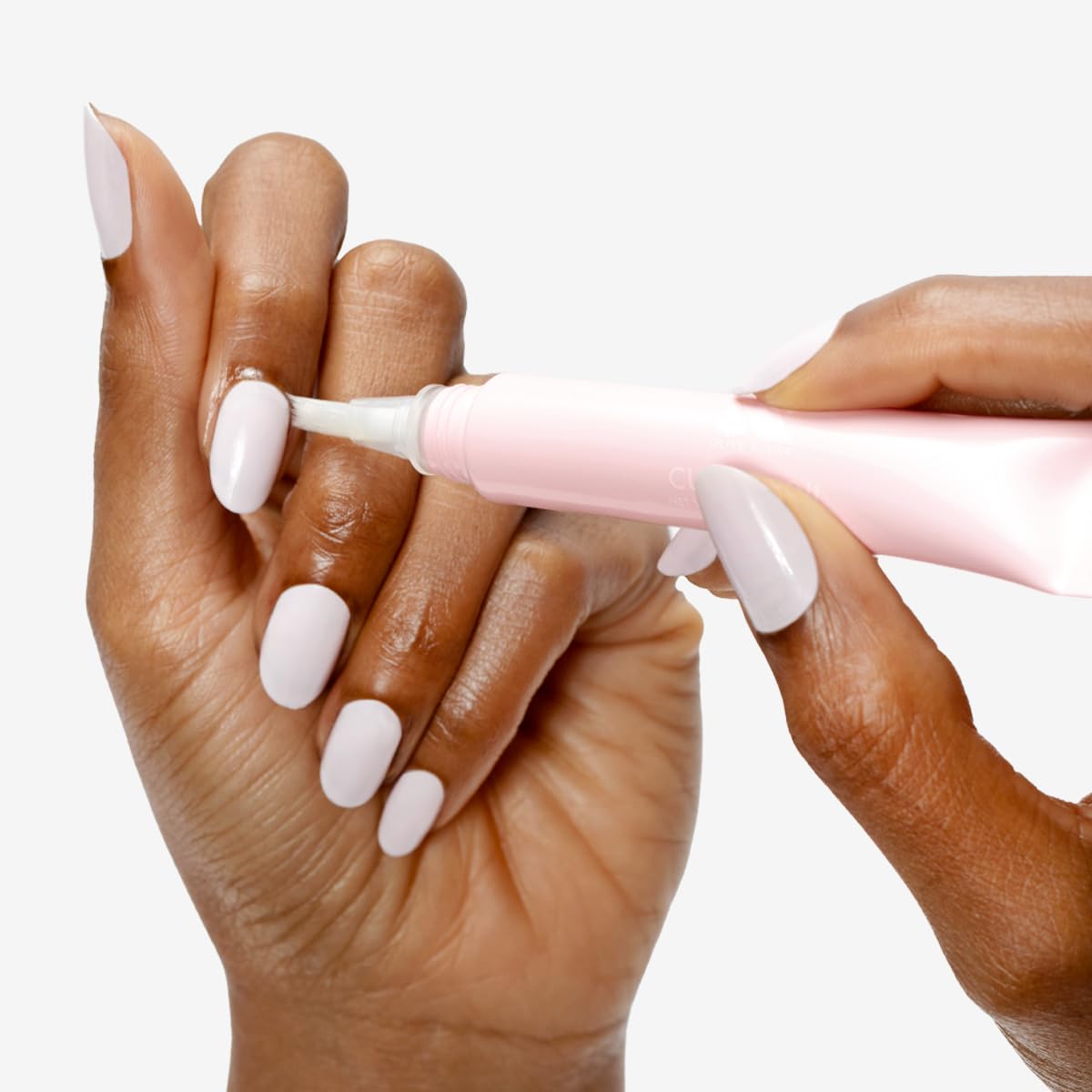 Olive & June brush-tip applicator close-up for precise, mess-free application