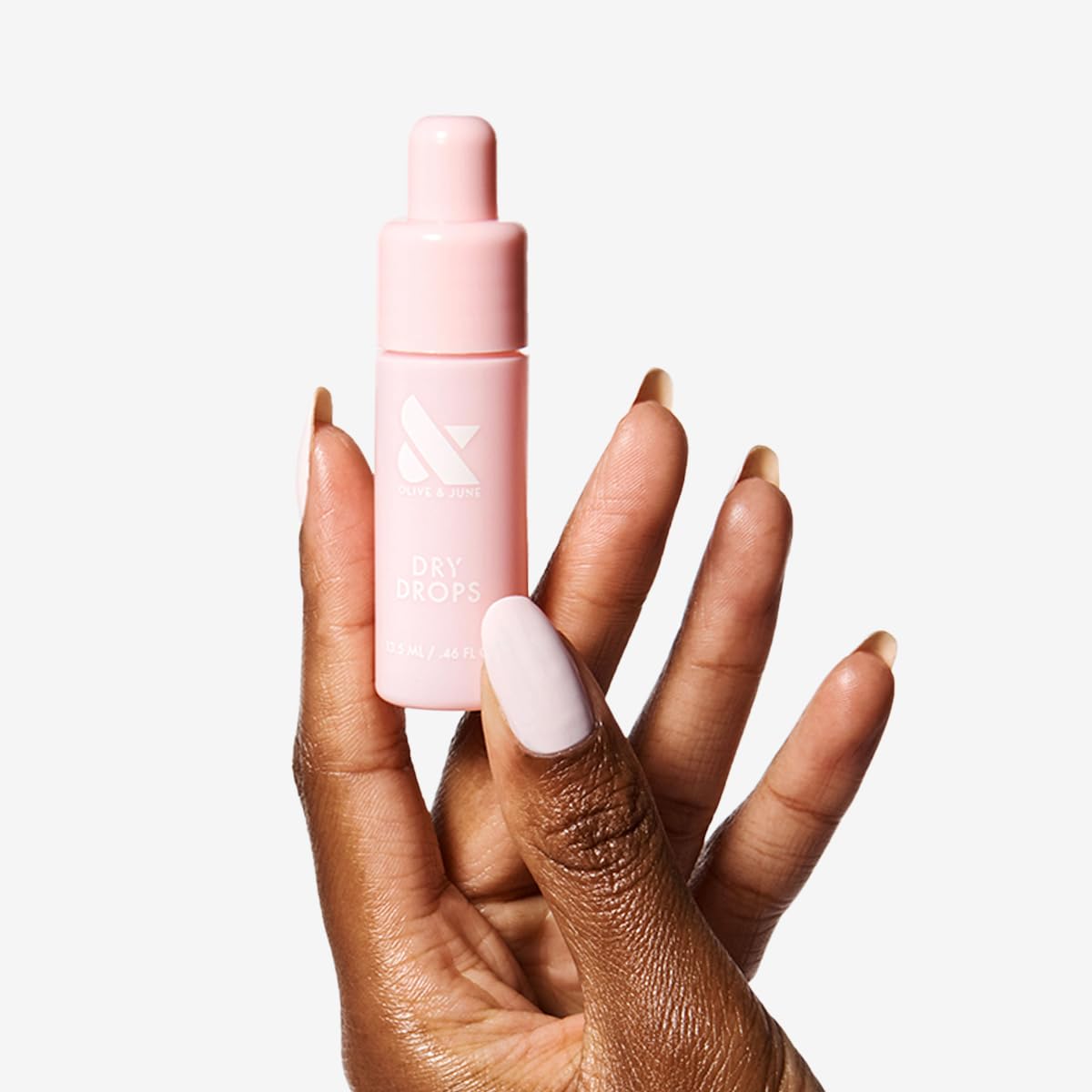 Olive & June applicator tip close-up for precise one-handed drops