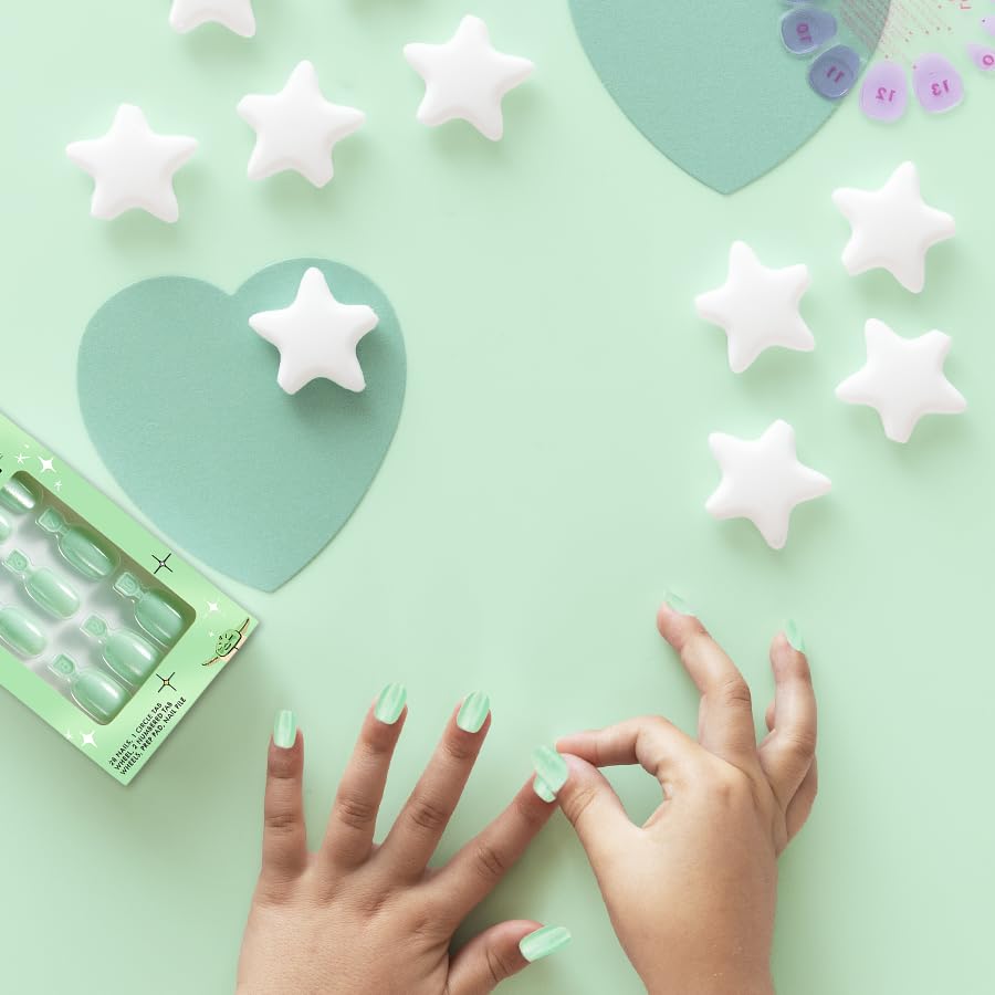 Child wearing Olive & June press-ons enjoying playtime with durable, stylish nails