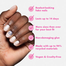 Olive & June press-on held between fingers showing natural curve and secure fit benefit