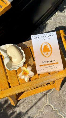 Olivia Care soap held in hand to show bar size and travel-friendly convenience