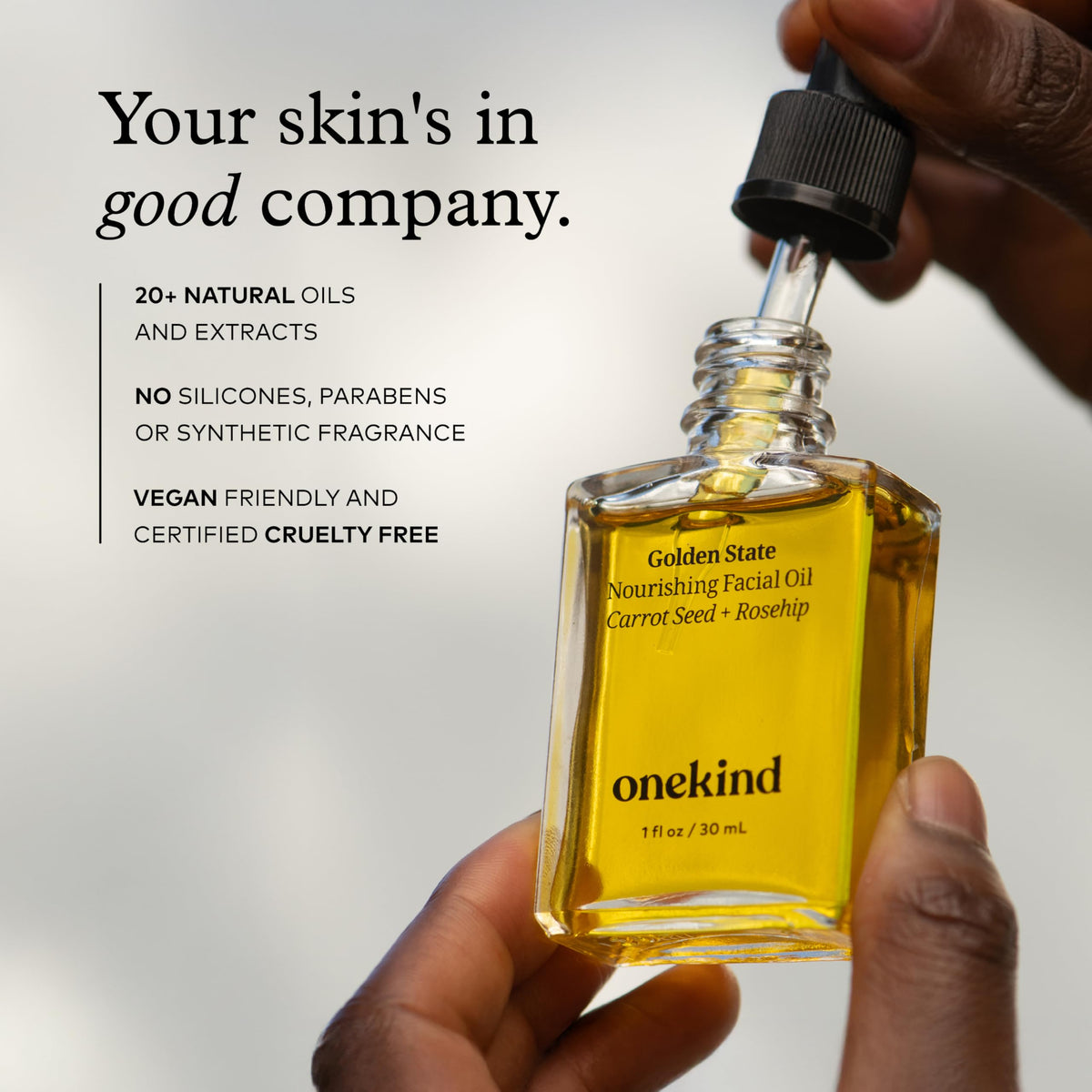 onekind bottle in hand for scale showing compact size and travel-friendly convenience