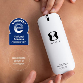 oneskin bottle next to hand for scale showing compact 50 mL travel-friendly benefit