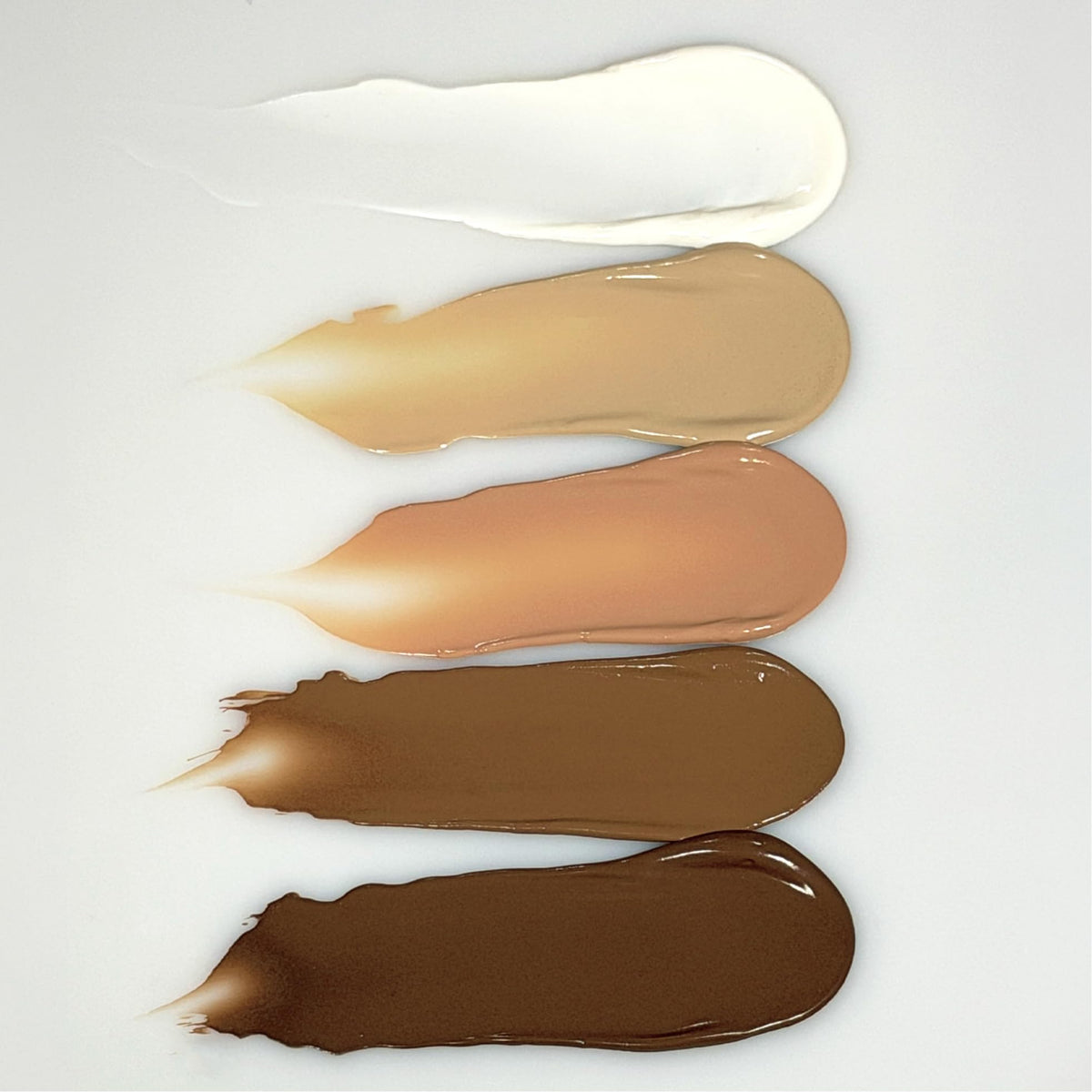 oneskin being applied to cheek illustrating smooth coverage and mineral protection