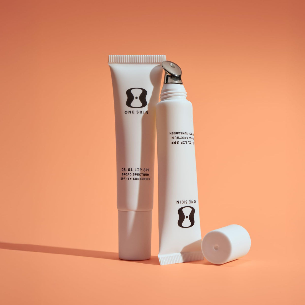 oneskin lip stick in hand showing 7 mL travel-friendly scale