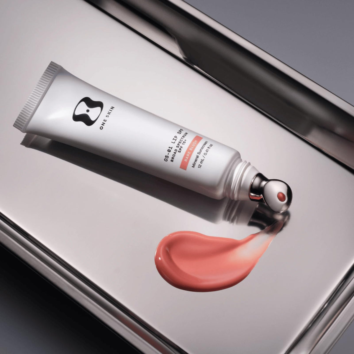 oneskin lip balm in outdoor setting protecting lips with mineral SPF