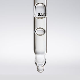 oneskin OS-01 bottle beside ruler showing compact 50 mL size