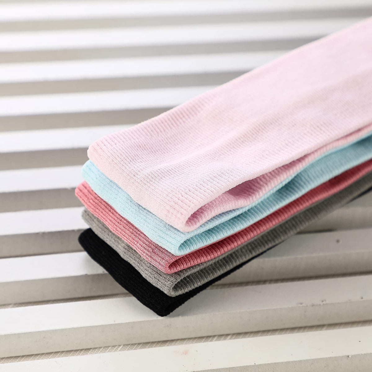 ONEYE flat lay of five solid colors showing outfit-matching options