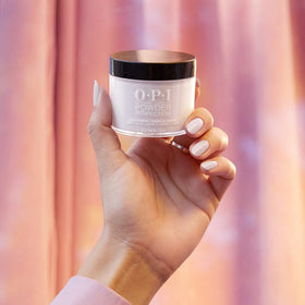 OPI application on natural nail in use demonstrating strong powder adhesion benefit
