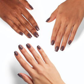 OPI hands applying a press-on with glue demonstrating quick, simple application
