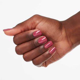 OPI on painted nails in hand showing Aurora Berry-alis durable shine benefit