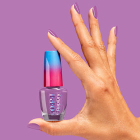 OPI bottle next to coin showing scale and portability for travel-friendly nail care