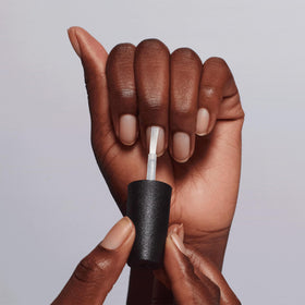 OPI Chip Skip Primer next to fingers to show size and professional usage benefit