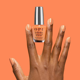 OPI Dreamsicle swatch on nail tip displaying sheer orange shimmer and salon shine