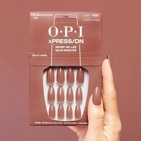OPI El Mat-Adoring You worn on hand lifestyle image showing elegant long almond tan nails for events