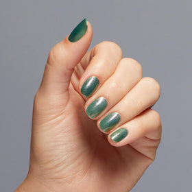 OPI painted nails on hands showing wearable green shimmer benefit
