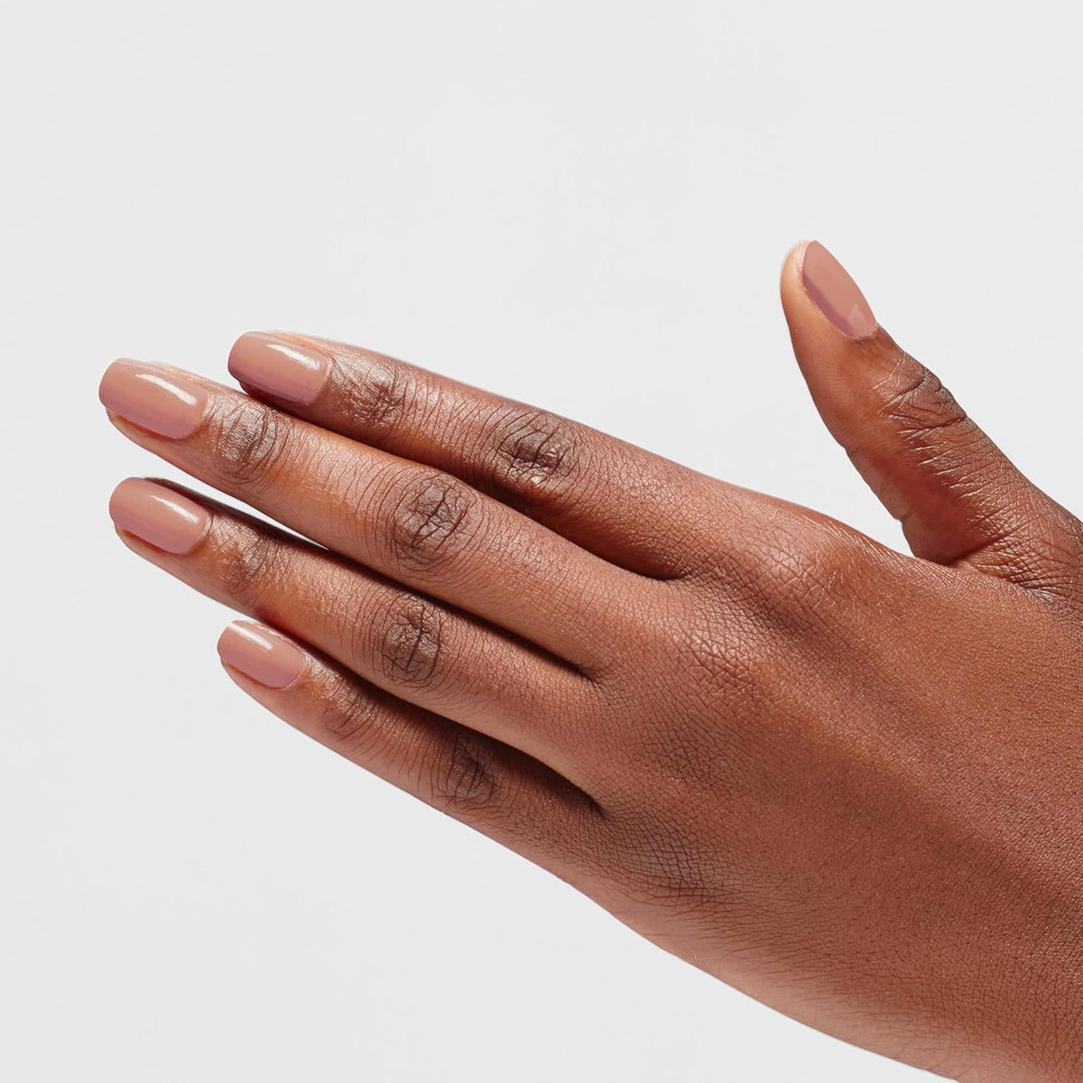 OPI manicured hand wearing Barefoot in Barcelona for polished look