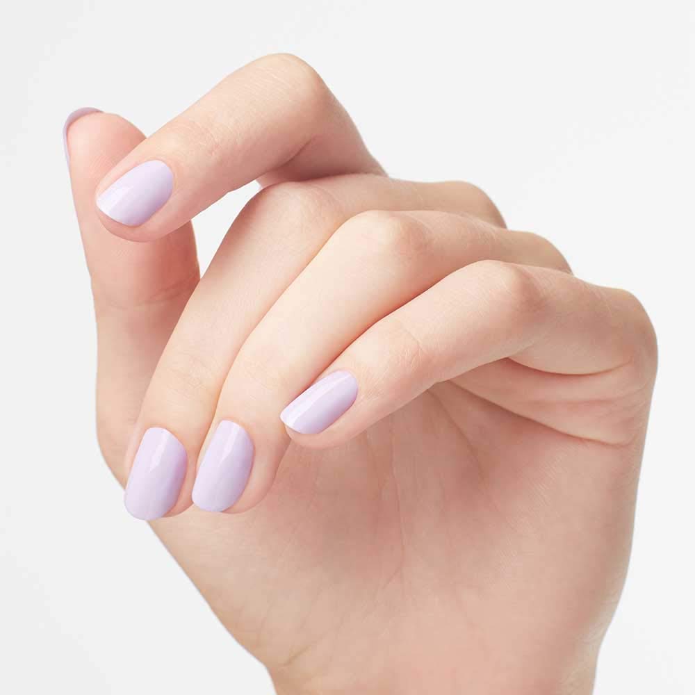 Hands with OPI lavender manicure in a beach-inspired lifestyle setting