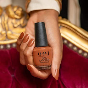 OPI bottle being applied to nails demonstrating even application benefit