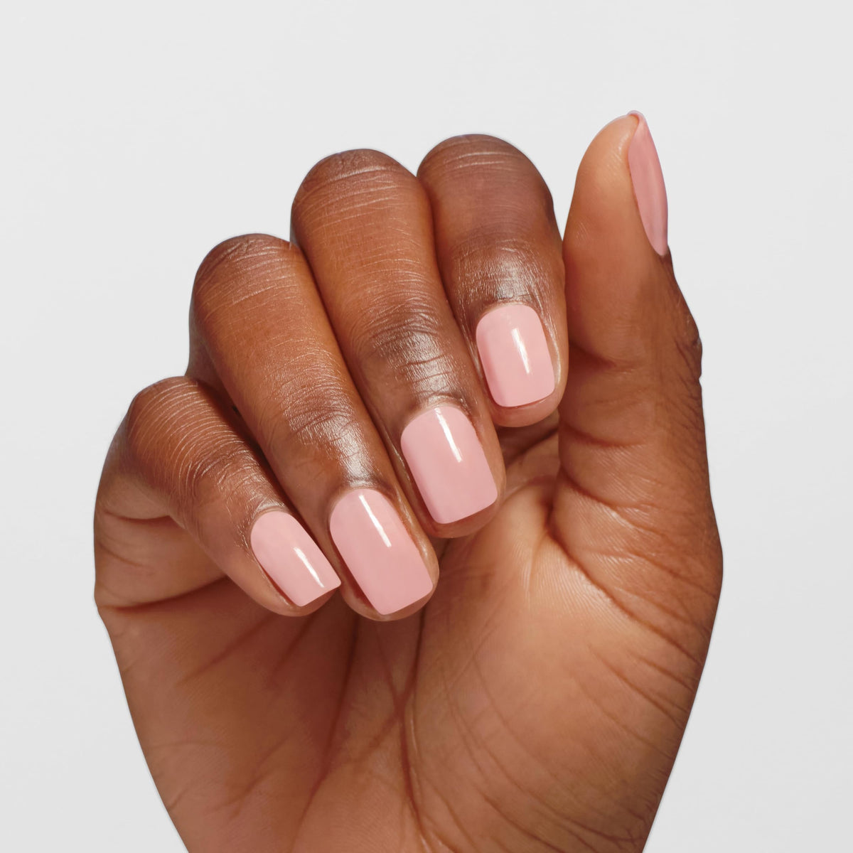 OPI swatch on nail wheel showing translucent pale pink buildable coverage benefit
