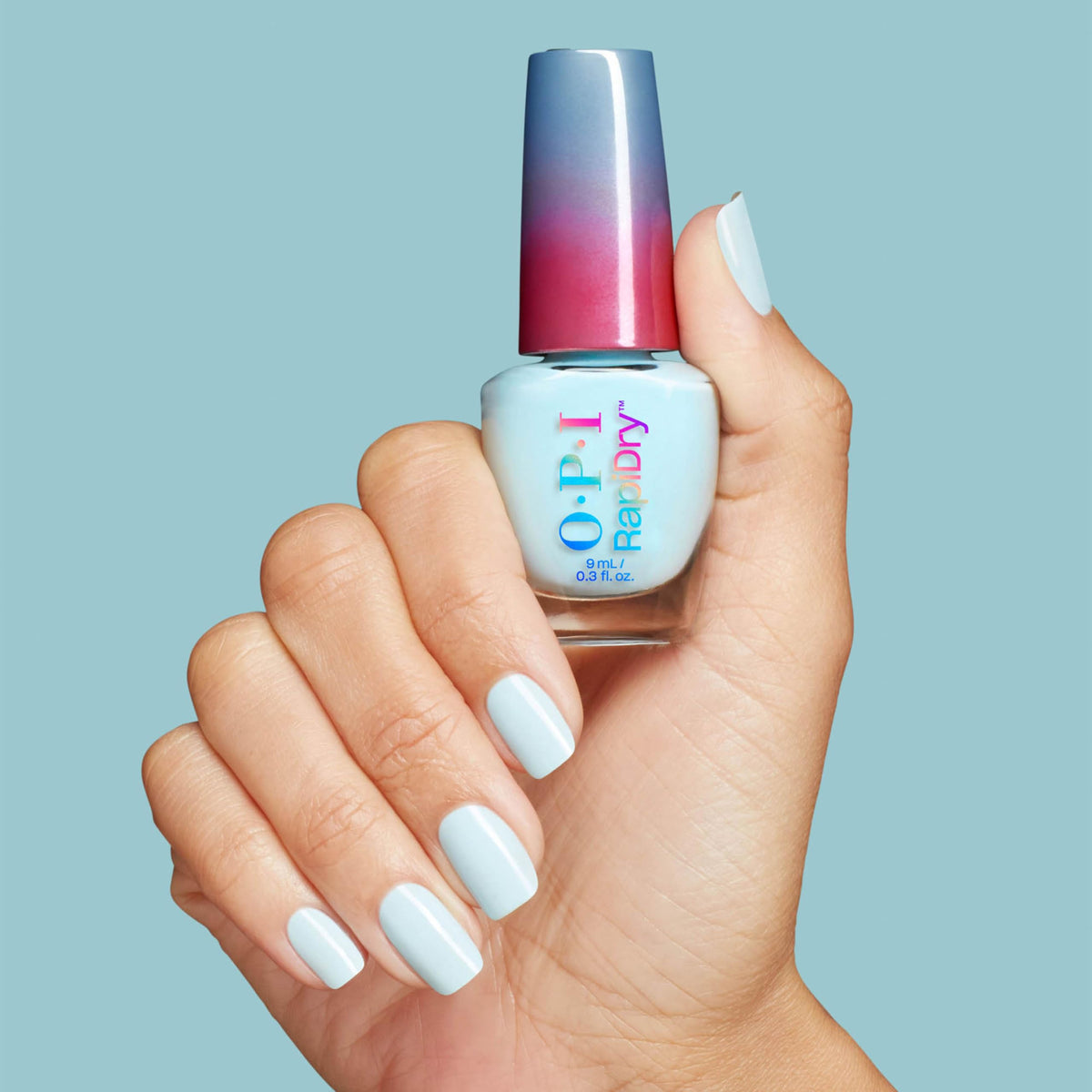 OPI bottle next to a coin showing compact size for at-home convenience