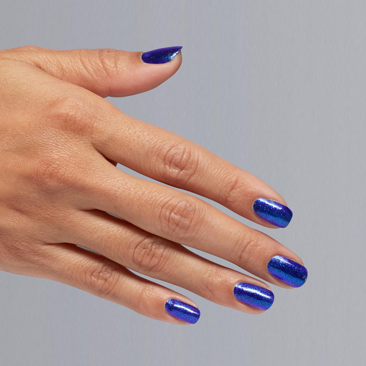 Manicure wearing OPI Scorpio Seduction showing rich cobalt-blue color and chip resistance