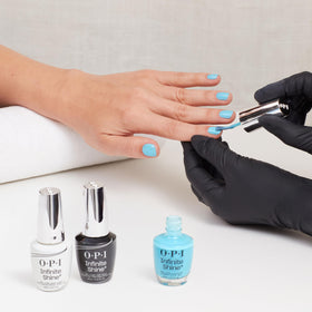 OPI manicured hand on beach towel showing summery lifestyle appeal