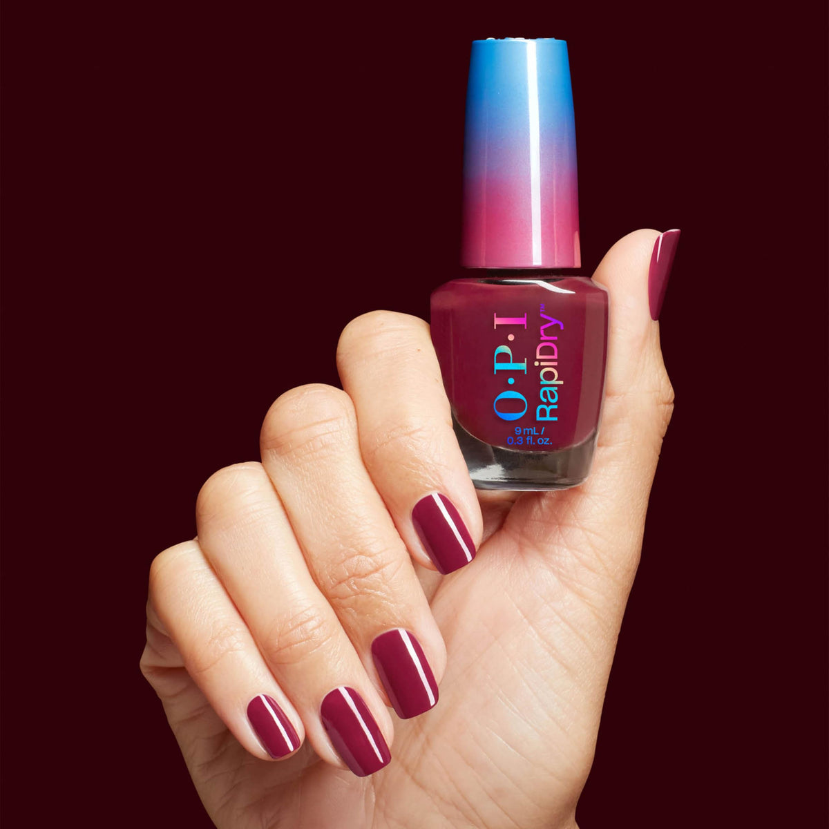 OPI lifestyle shot with winter outfit highlighting berry polish for holiday look