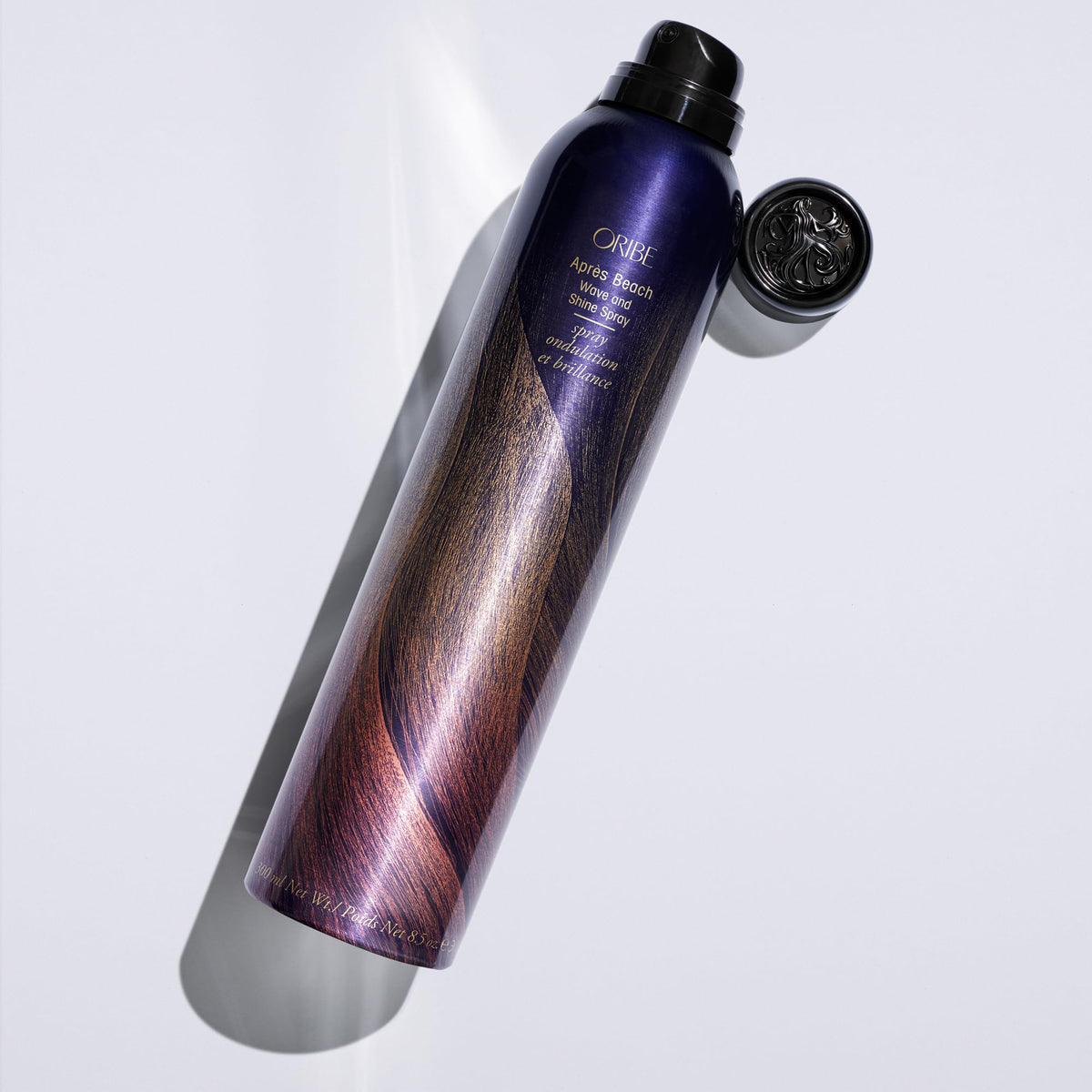 Oribe Après styled hair lifestyle shot showing tousled waves and touchable shine