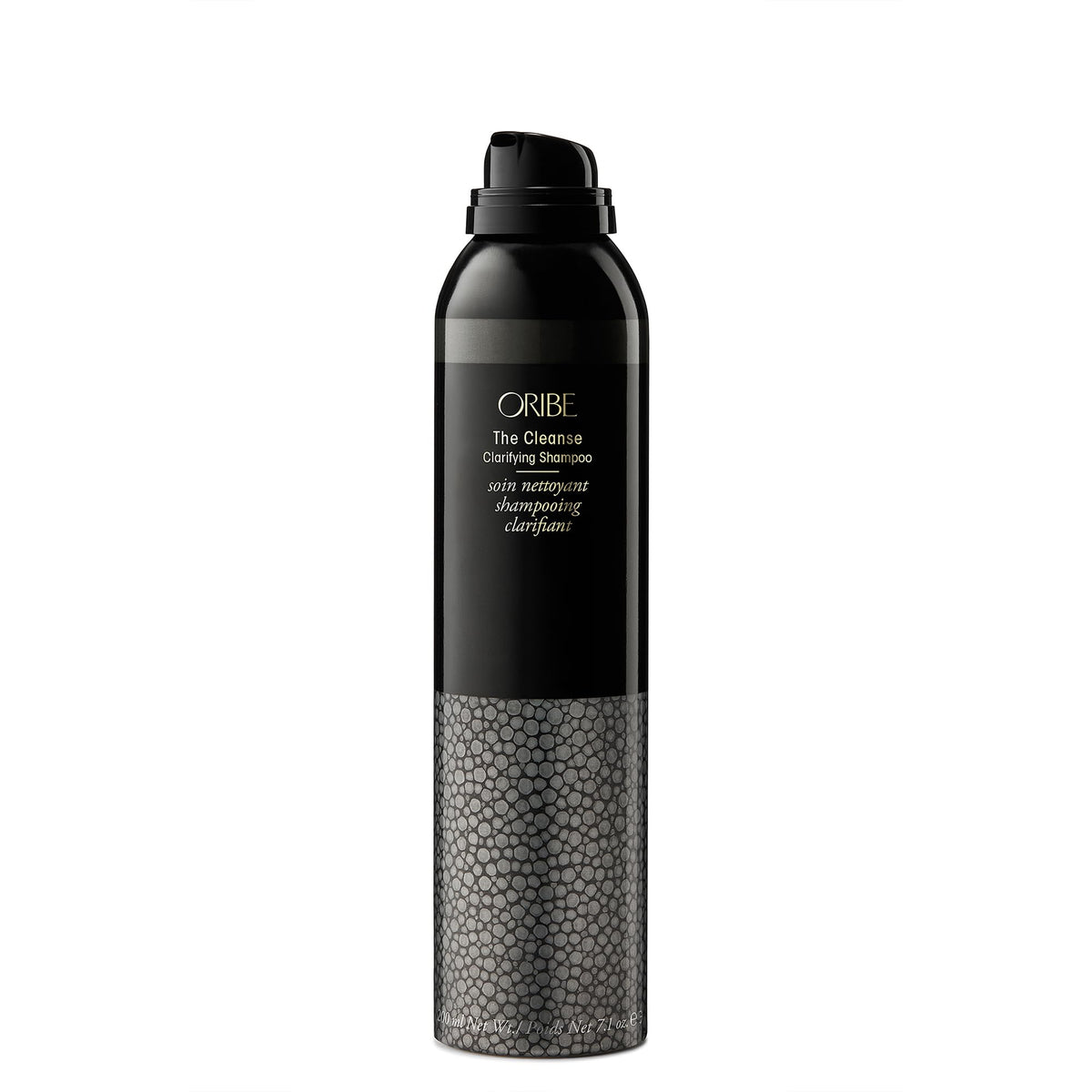 Oribe bottle next to hairbrush for scale and preparation benefit before salon treatments