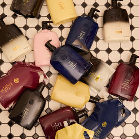 ORIBE bottle on bathroom shelf lifestyle image promoting salon-quality benefit