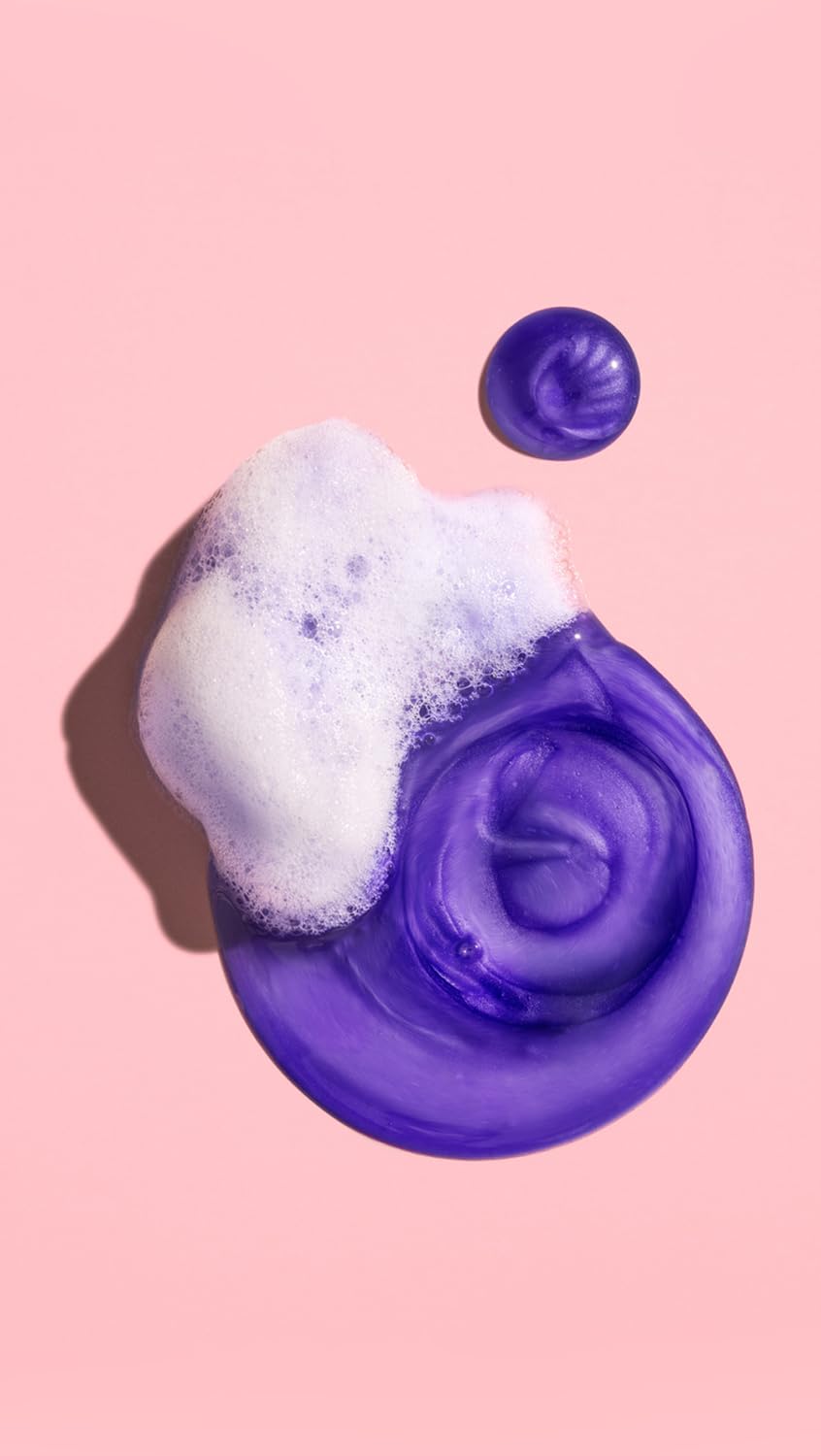 Styling shot of Oribe Bright Blonde shampoo in use rinsing brassiness for brightness