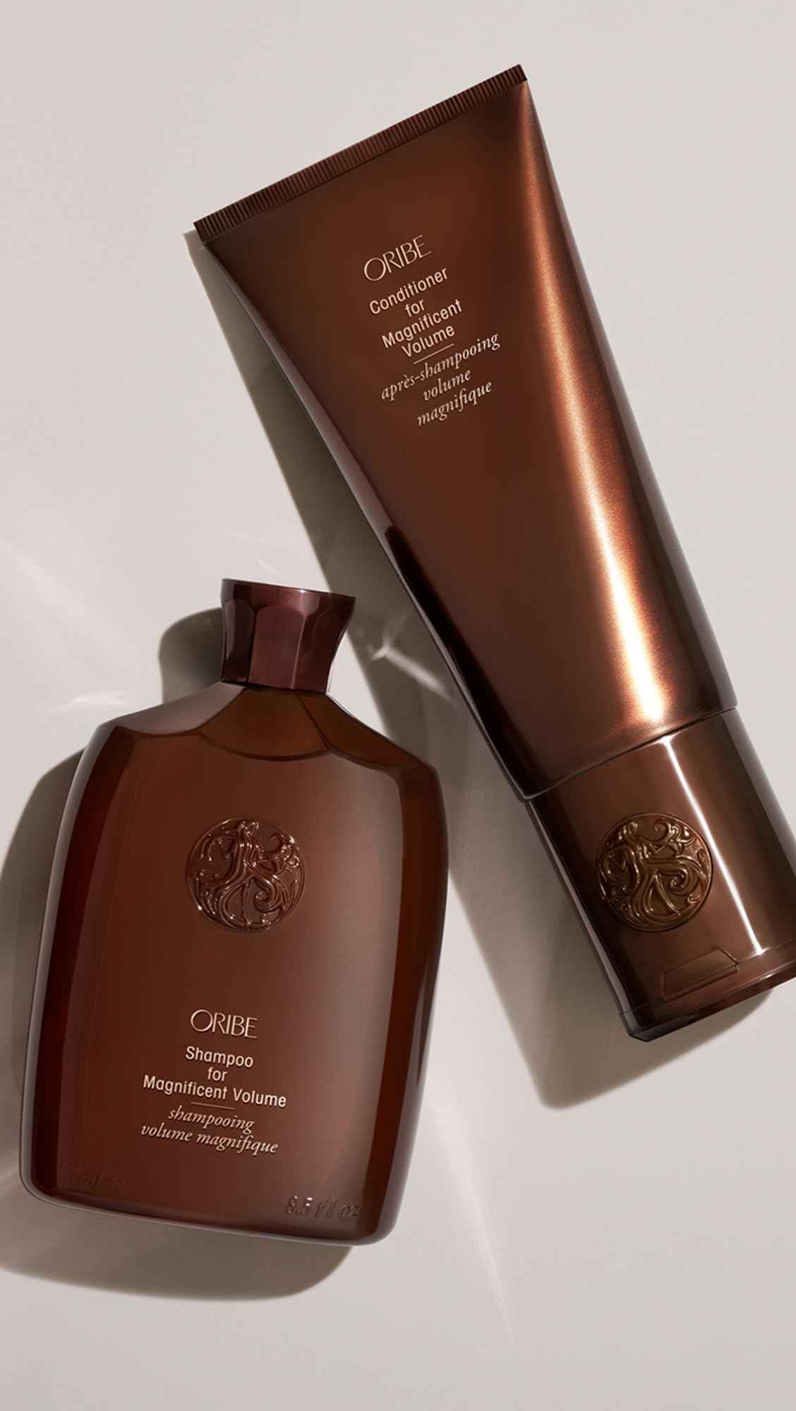 Oribe conditioner bottle in shower setting suggesting daily hair care benefit