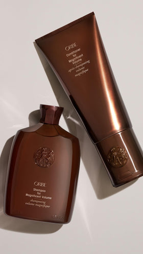 Oribe conditioner bottle in shower setting suggesting daily hair care benefit