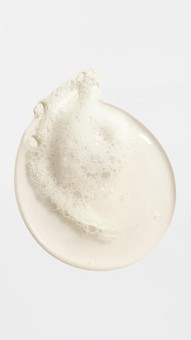 ORIBE body wash in use on wet skin demonstrating gentle cleansing and scent