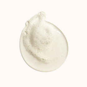 ORIBE close-up pearlescent texture of body wash showing creamy consistency