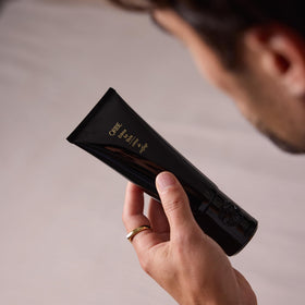 ORIBE stylist using crème during a salon blowout for controlled finish