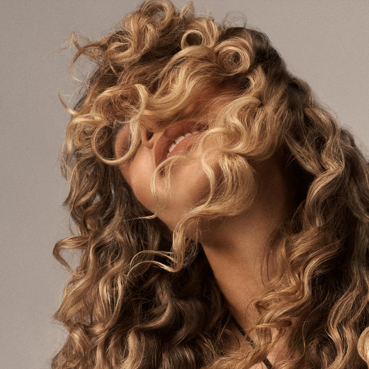 Oribe curl gel next to common items showing 8.5oz size and scale