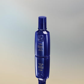 Oribe Featherbalm on a vanity with styling tools portraying everyday salon-quality polish