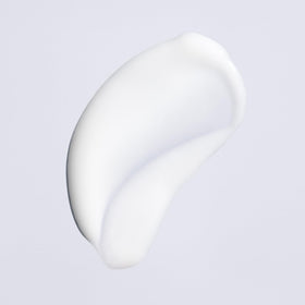 Oribe Featherbalm beside a 3.4oz scale for clear size and travel-friendly convenience