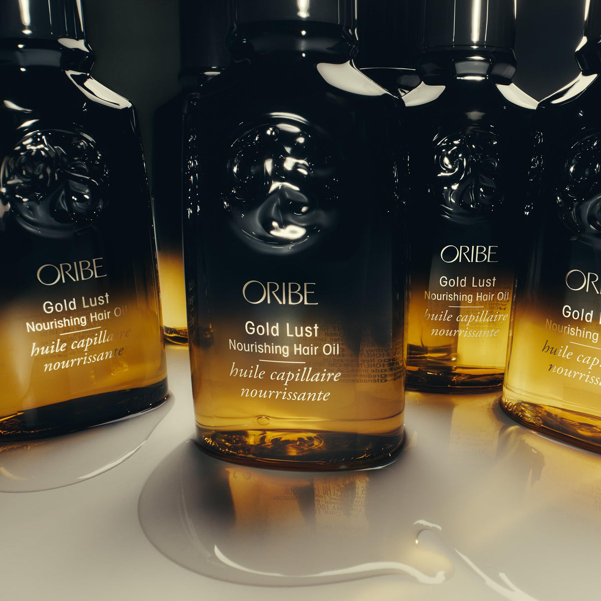 Applying Oribe Gold Lust on damp hair to detangle and protect before heat styling